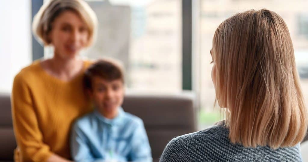 Consultant interviewing mother and child